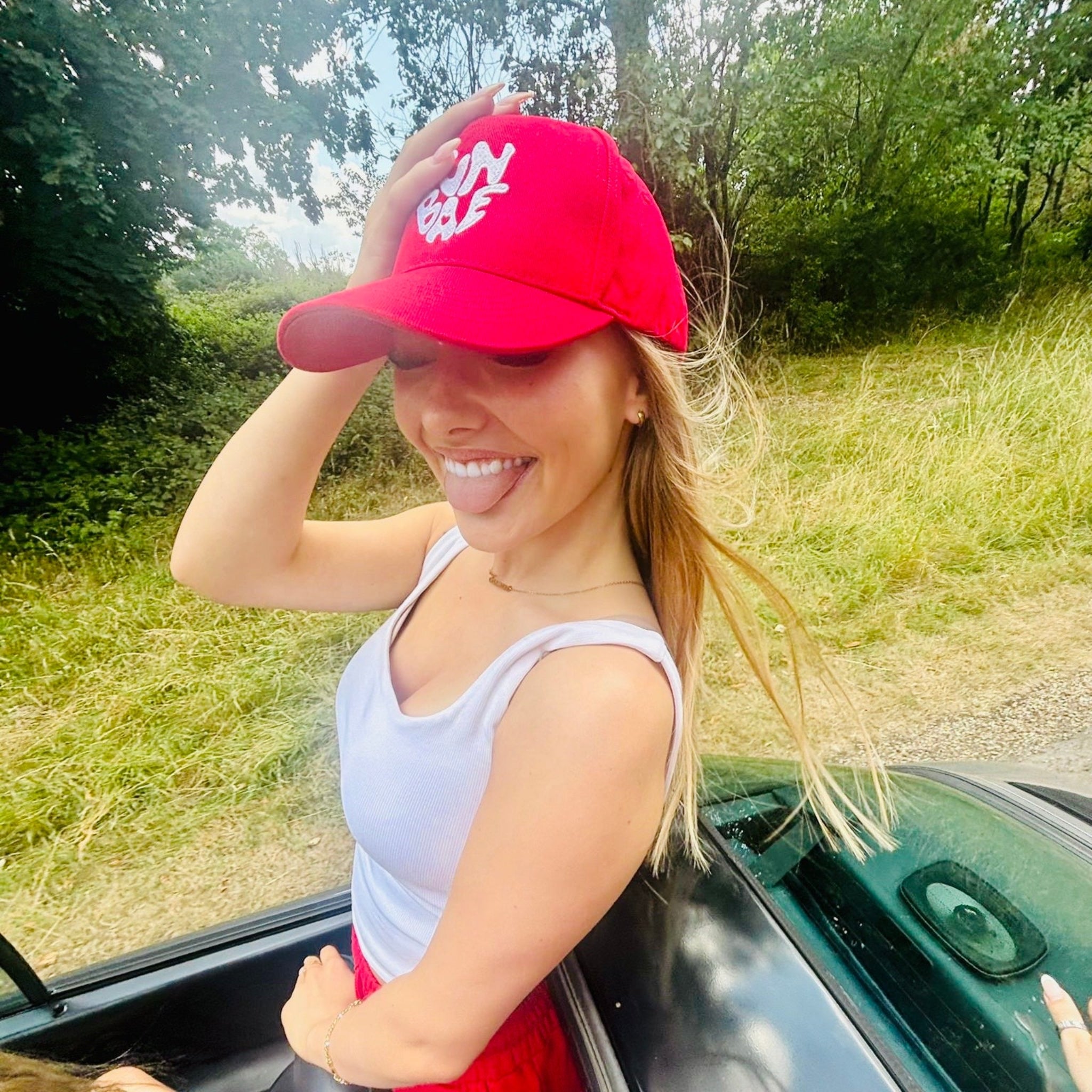 Sunbae Glower wearing SUNBAE Solar Cap with Glazed Heart Embroidery in Red