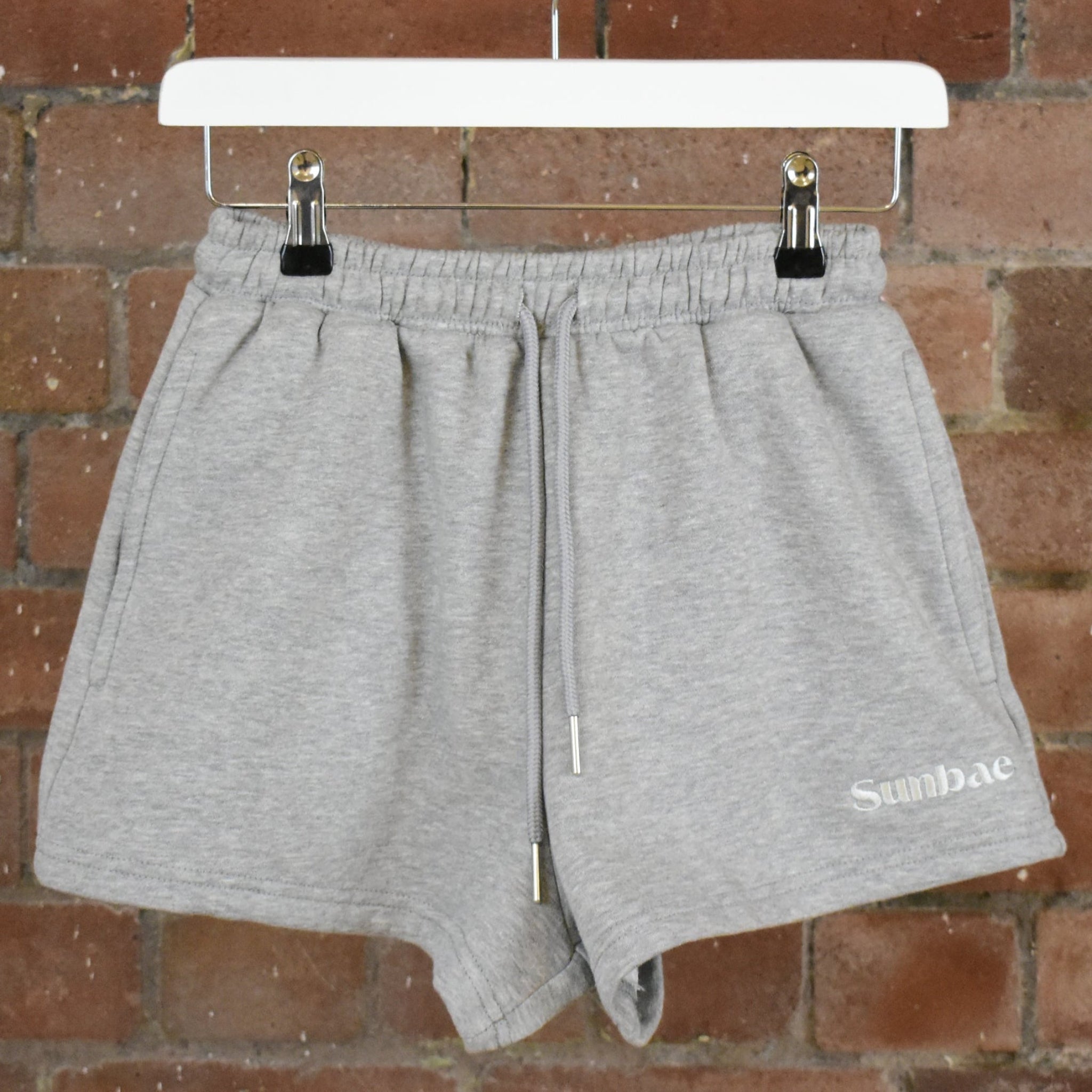 SUNBAE Sweat Short on a brick wall