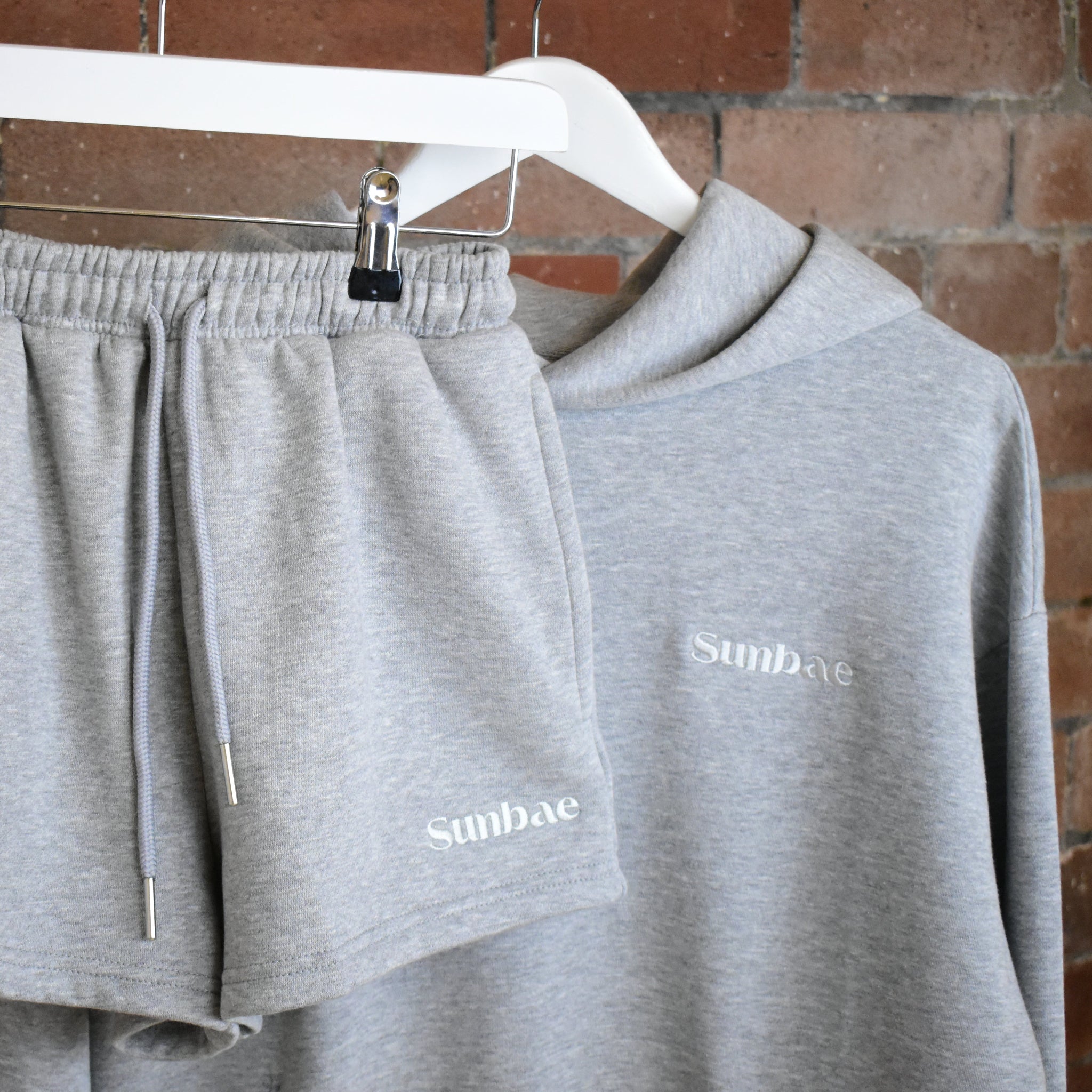 SUNBAE Grey Marl Hoodie and Sweat Short on a brick wall