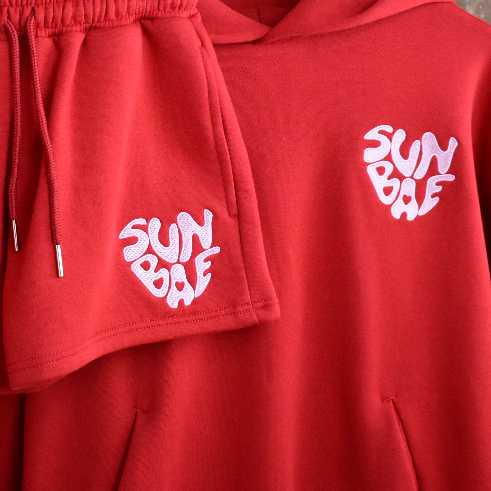 Red SUNBAE hoodie and shorts set with matching heart design.