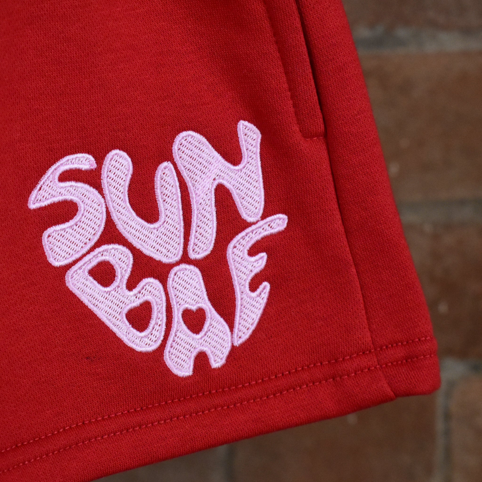 Red SUNBAE shorts with Pink Embroidered logo