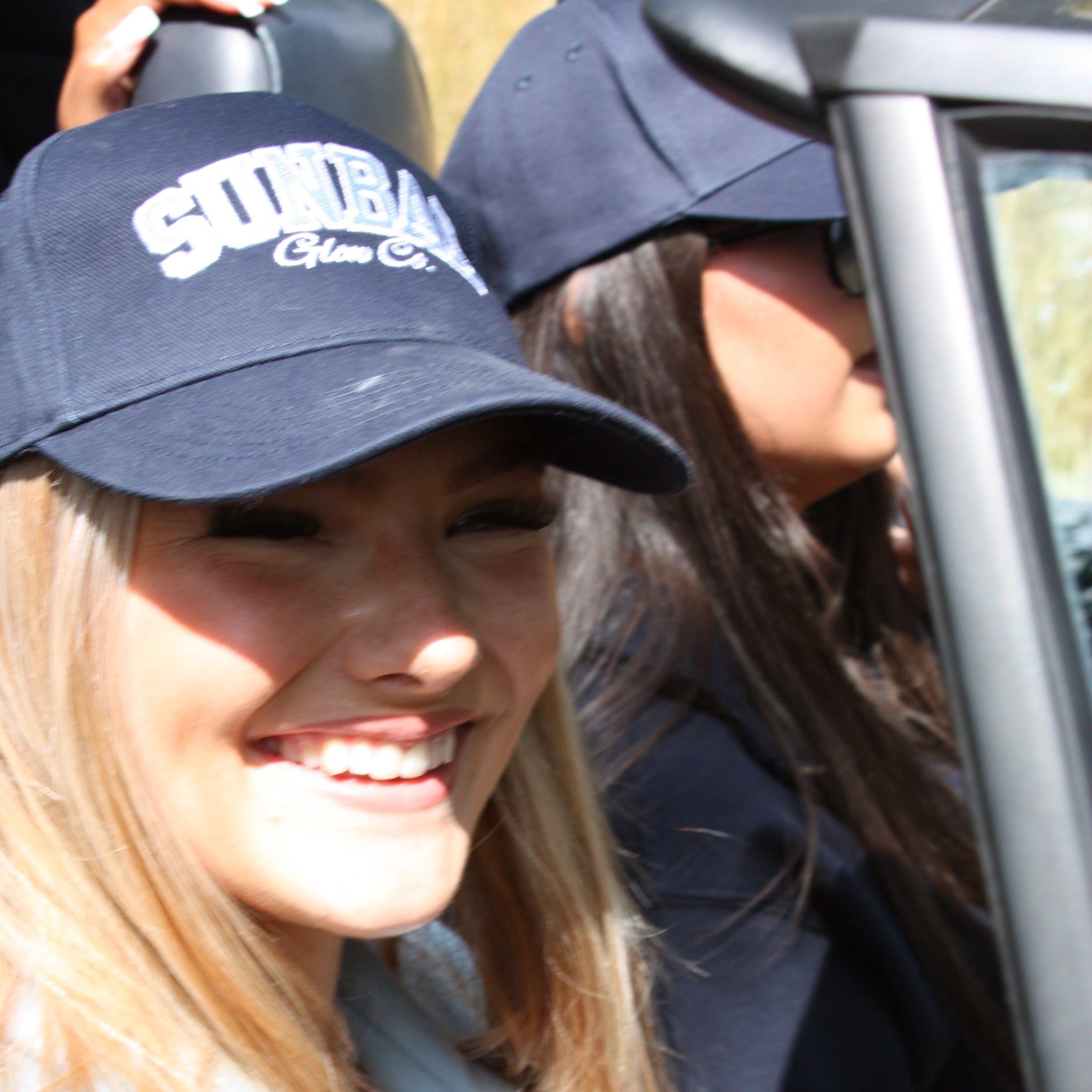 Sunbae Glower wearing a Sunbae Solar Cap in a car