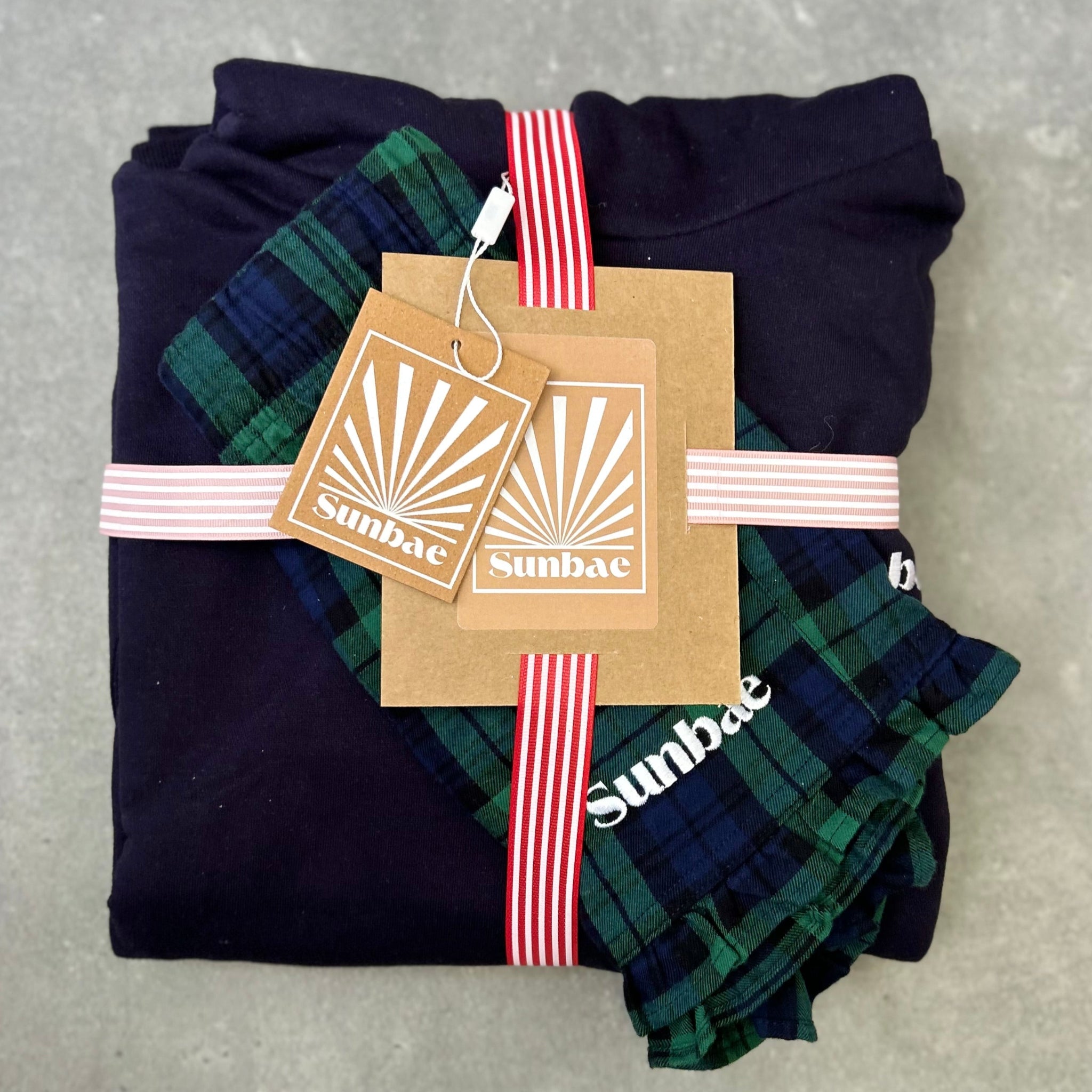 Folded navy sunbae hoodie with check short BUNDLE on a gray surface