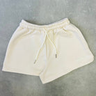 Beige shorts on a gray concrete floor