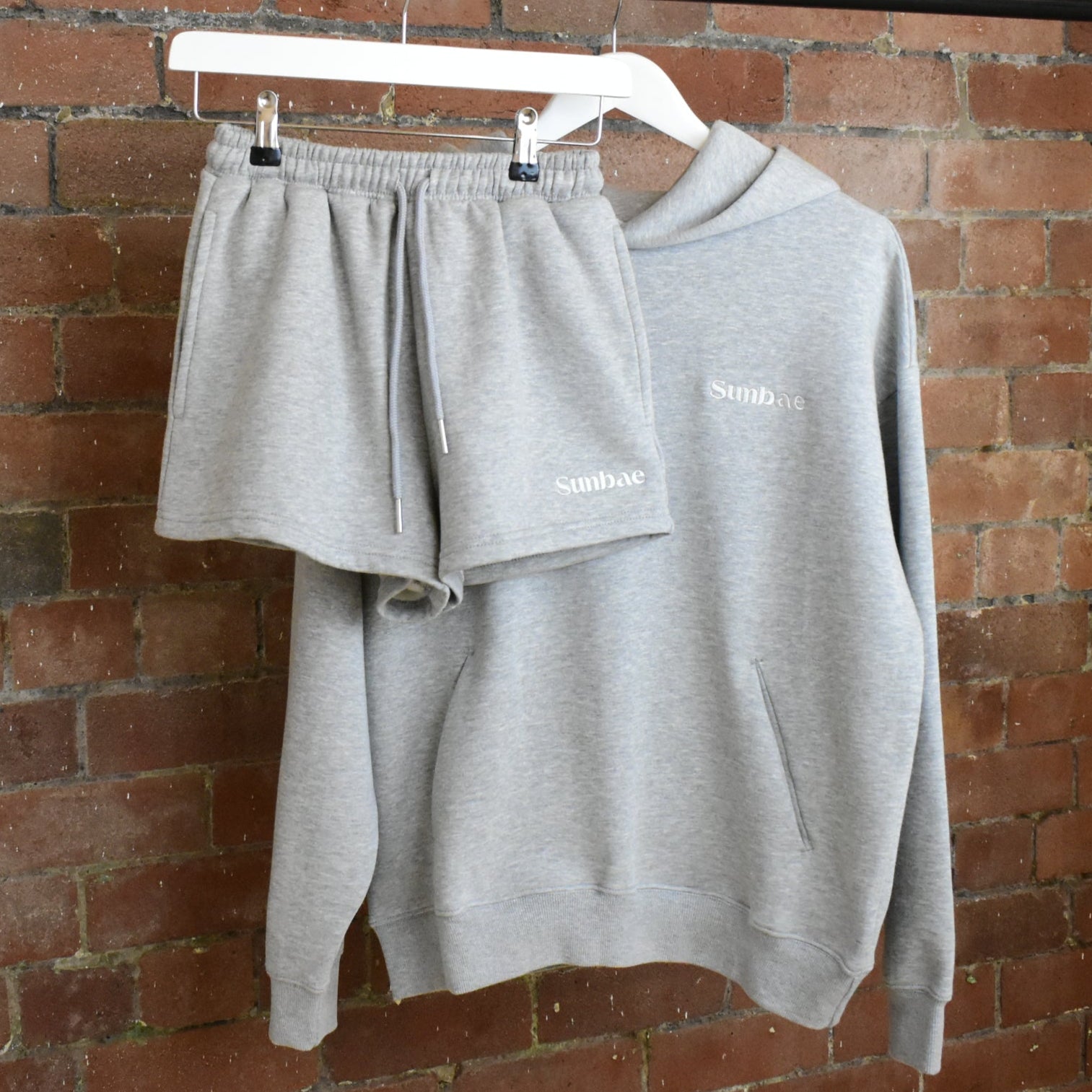 SUNBAE Hoodie and Short set on a brick wall