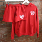 Red SUNBAE Glazed Heart hoodie and shorts set on a brick wall background