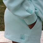 Mint Sunabe hoodie with a brand logos on the sleeve and short